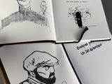 a drawing of a man with a beard and a hat in a book