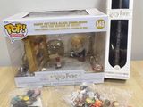 harry potter figurines and accessories on a table in front of a box