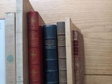 many books that are on a shelf on the table