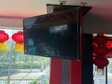 a television mounted on the wall in a restaurant