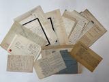 several old papers are stacked on top of each other on a table