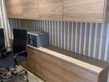a picture of a modern office with a desk and chairs