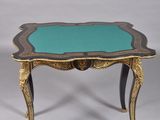 a small table with a green top and black legs