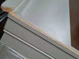 a white cabinet with a drawer on top of it in a room