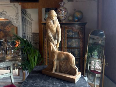 a statue of a man and a dog on a table