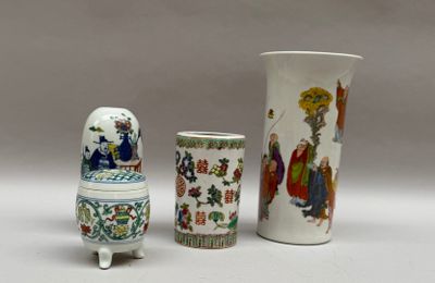 trois vases et une tasse posés sur une table