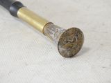 a gold and black cane with a dragon on it