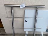 a white toilet sitting next to a metal rail