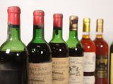 several bottles of wine are lined up on a shelf