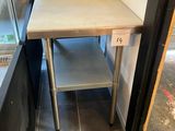 a small table with a basket on top of it