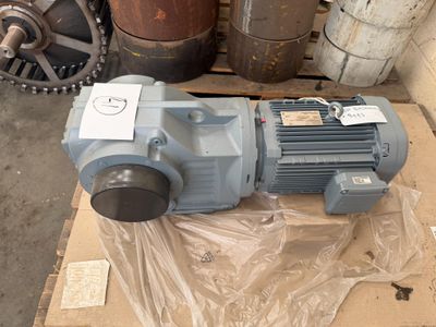 a blue motor sitting on a box in a warehouse