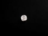 a close up of a diamond on a black surface