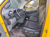a yellow truck with black leather seats and a steering wheel