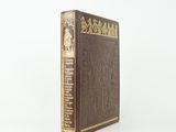 a brown book sitting on top of a white surface