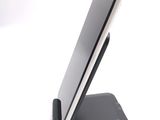 a cell phone on a stand on a white surface