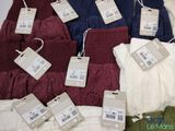 a pile of clothes with price tags on them