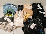 a pile of clothes and shoes on a table