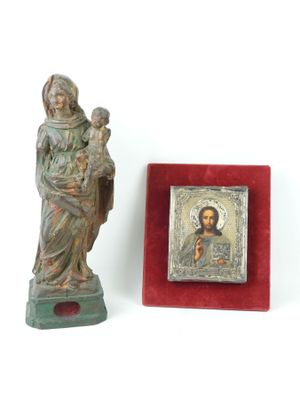 statue of jesus holding a child in his arms next to a picture of a woman