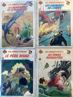 four comic books on display in a store window
