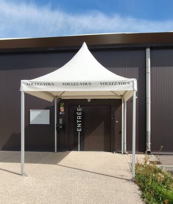 a white tent that is outside of a building