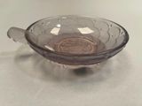 a glass bowl with a spoon in it on a table