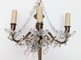 a crystal chandelier with two candles on it