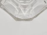 a clear glass ashtray with a silver lid