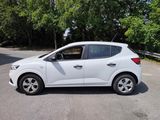 the white car is parked on the side of the road