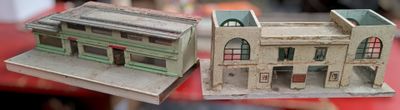 two model buildings sitting on a red table