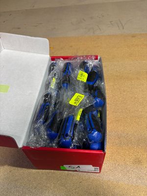 a red box with a bunch of blue and yellow screws in it