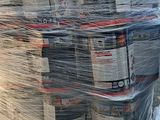 a large stack of newspapers wrapped in plastic on a pallet