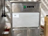 an image of a stainless steel ice machine in a warehouse