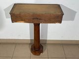 a small wooden table with a wooden top on a tiled floor