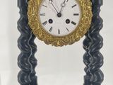 a black and gold clock sitting on top of a table