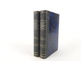 two books sitting on top of each other on a white surface