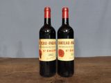 two bottles of wine sitting on a wooden table