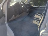 the interior of a car with the door open and the driver ' s seat down