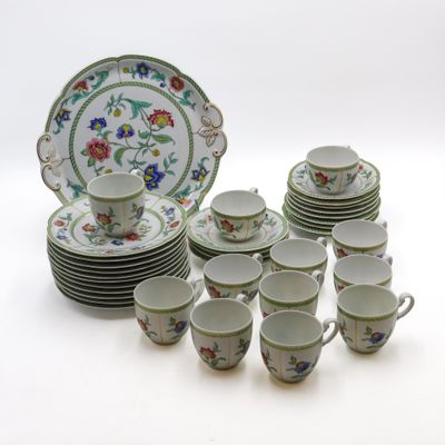 un grand nombre de tasses et de soucoupes sur une table
