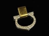 a close up of a gold and diamond ring on a black surface