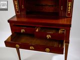 a small wooden cabinet with two drawers on it