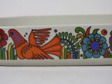 a colorful bowl with a bird and flowers on it