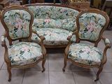 three chairs and a couch in a room