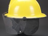 a yellow hard hat with a face shield on top of it