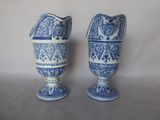 pair of blue and white vases sitting on top of a table