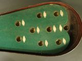 a green case with holes in it on a table