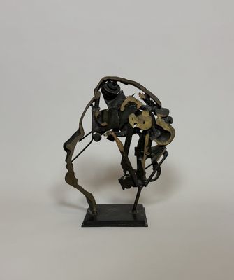 sculpture of a horse made out of metal parts on a white surface