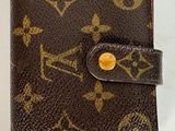 portefeuille Louis Vuitton marron avec finitions dorées