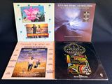 three vinyl albums of various movie titles on a black background
