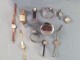 a lot of different watches and bracelets on the table
