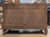 an old wooden bed in a room with a lot of furniture